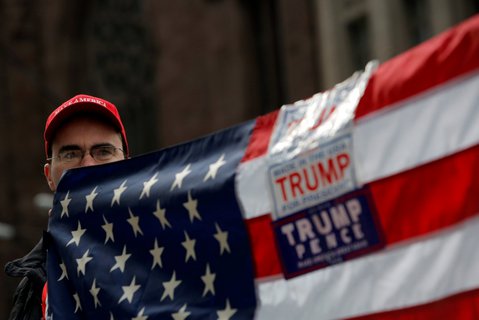 A man holds a flag during a rally in support of U.S. President Donald Trump at Trump Tower in Manhattan, New York, U.S.
X02844 / REUTERS