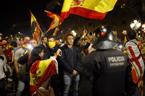 Unabhängigkeitsgegner rufen Slogans und schwenken spanische Flaggen, während sie nach der einseitigen Unabhängigkeitserklärung der katalanischen Regionalregierung durch Barcelona marschieren. Foto: dpa