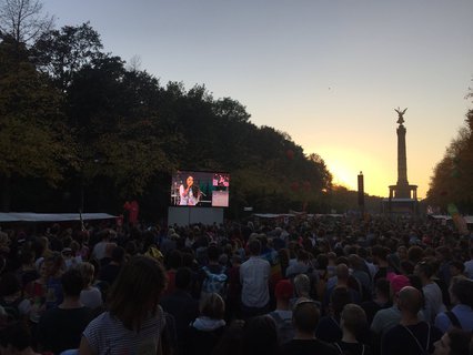 Demonstraten lauschen gespannt und applaudieren der Kundgebung.