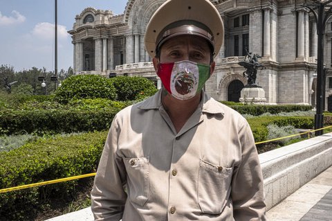 Ein Polizist trägt eine Maske in den Farben der Landesflagge.