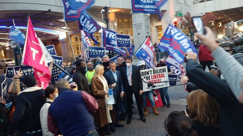 Pam Bondi (im braunen Mantel, links) und Corey Lewandowski (rechts neben ihr) vor dem Convention Center in Philadelphia.
