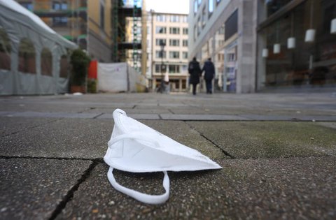Eine FFP2-Maske liegt in Münchens Innenstadt auf dem Boden.