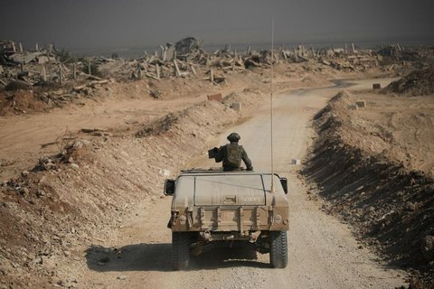 Israelische Sicherheitskräfte fahren während der von der israelischen Armee organisierten Tour für Journalisten, an den Ruinen von Gebäuden vorbei.