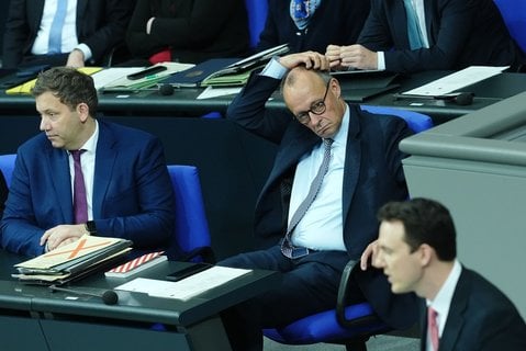 Pascal Reddig im Bundestag. Im Plenum sitzen Merz und Klingbeil. 